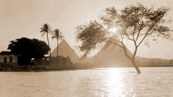 A sailboat plies the Nile River near the Giza Plateau